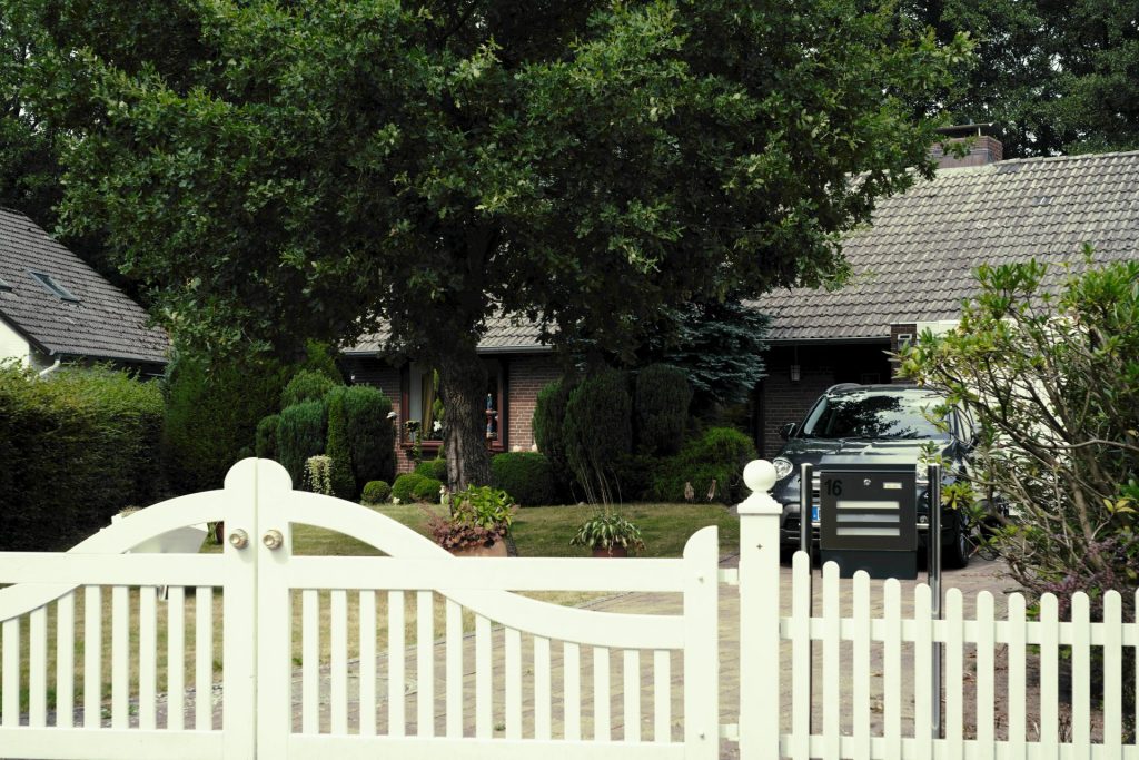 a truck parked in front of a white fence